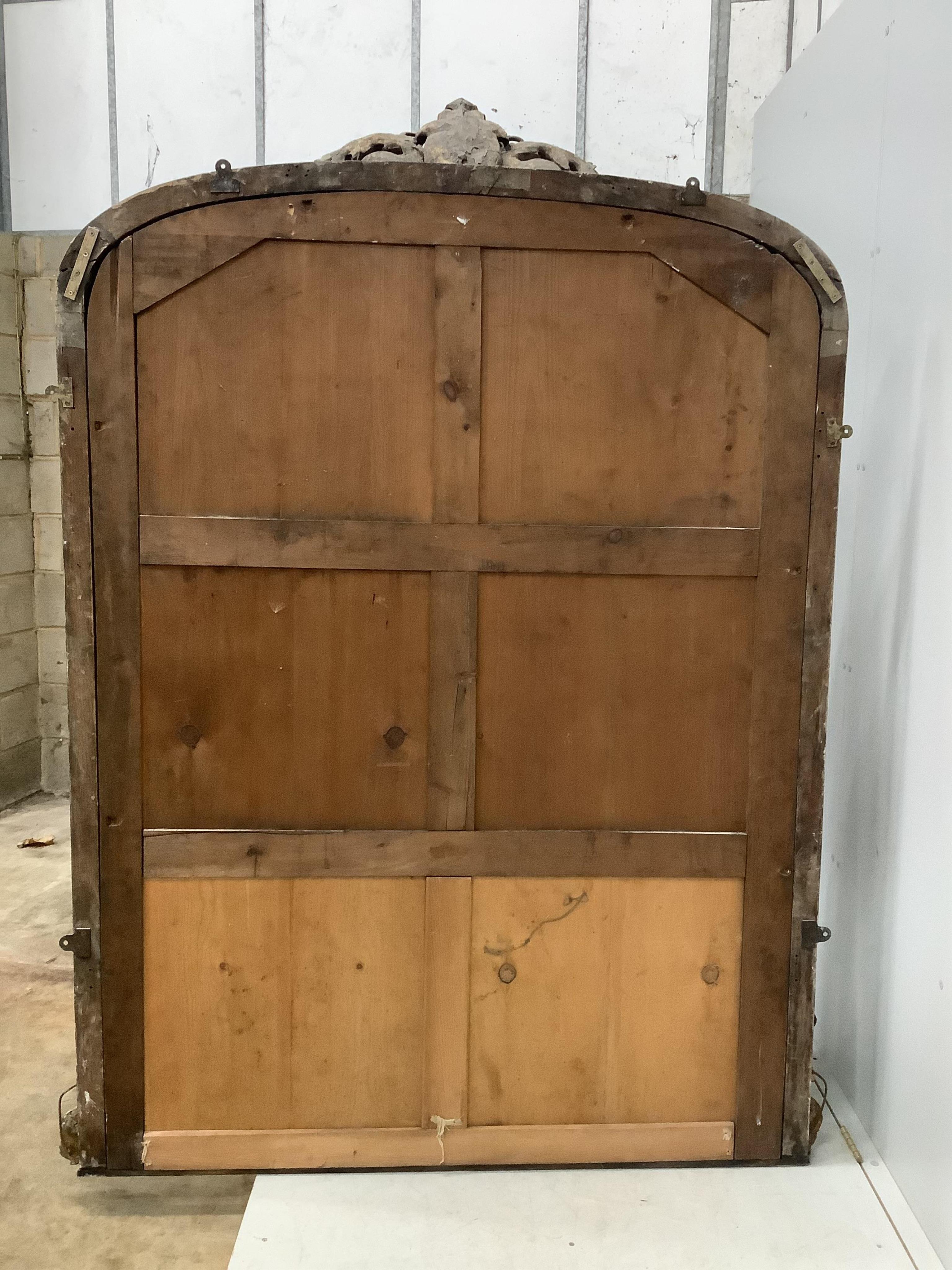 A Victorian giltwood and composition overmantel mirror with cartouche pediment, width 140cm, height 201cm. Condition - fair, three areas of lost gesso